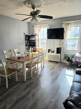 a view of a livingroom with furniture and a flat screen tv