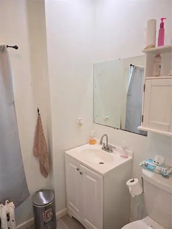 a bathroom with a sink toilet and a mirror