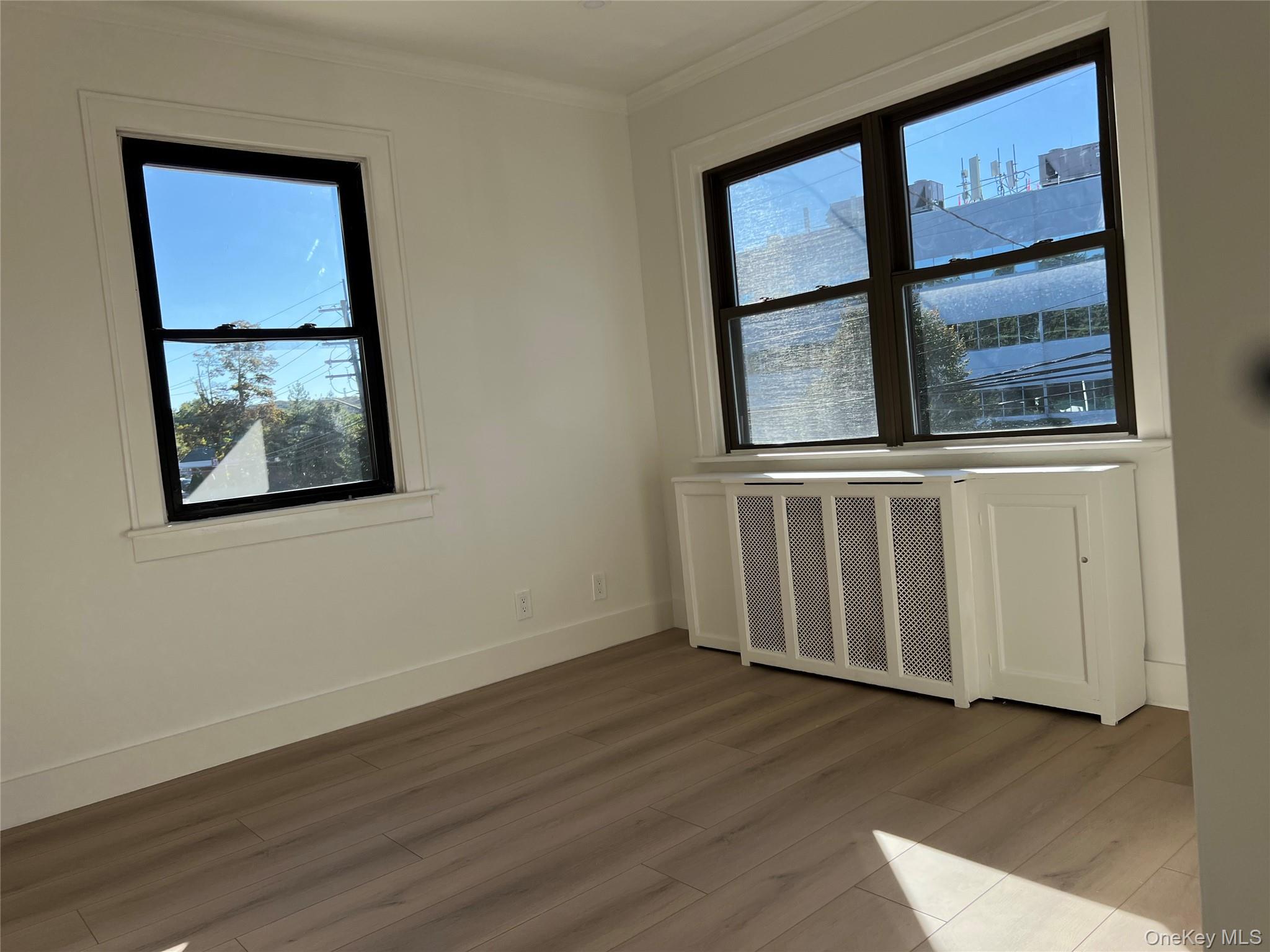 28 Walt Whitman Road Huntington Station, NY 11746 - Photo 14 of 17 a view of an empty room with wooden floor and a window