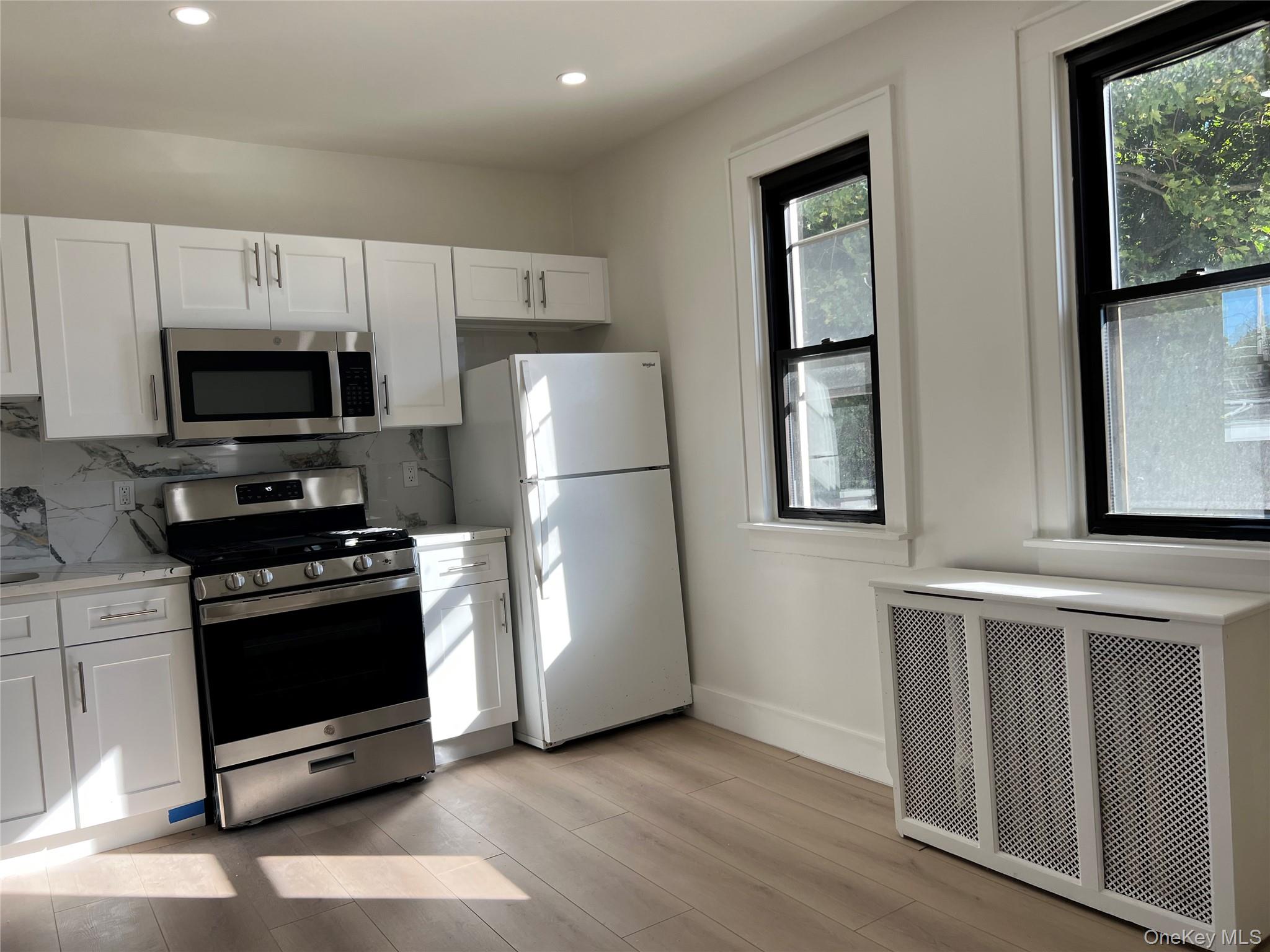 28 Walt Whitman Road Huntington Station, NY 11746 - Photo 10 of 17 a kitchen with stainless steel appliances a refrigerator stove and microwave