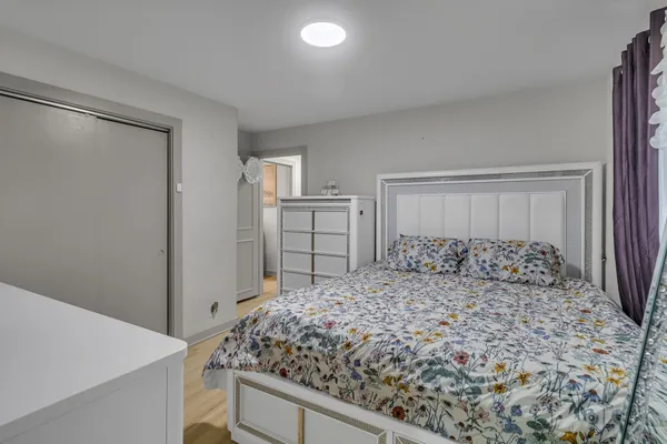 a bedroom with a large bed and a dresser