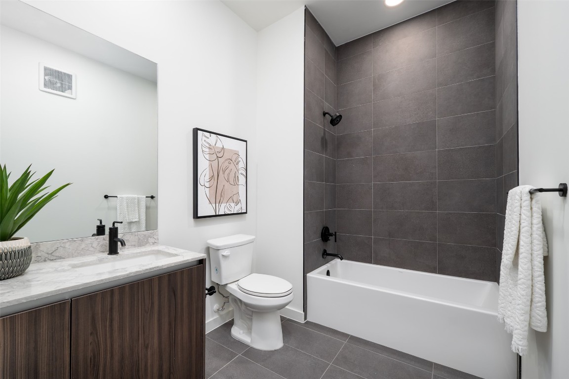 2209 South 1st Street, Unit 407 Austin, TX 78704 - Photo 18 of 30 a bathroom with a sink a toilet and shower