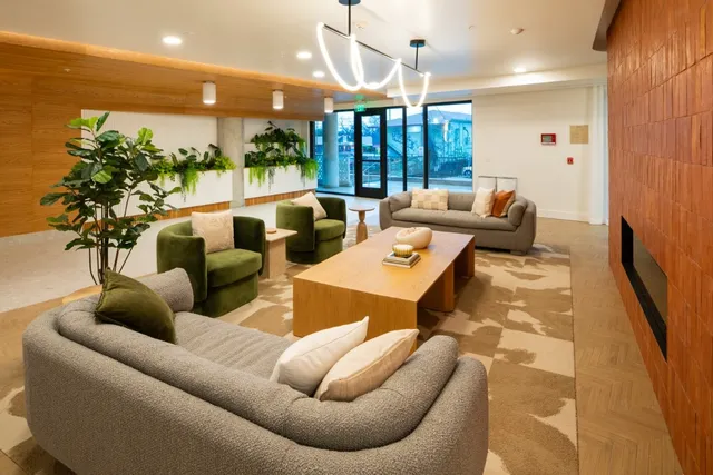 a living room with furniture a rug and a chandelier