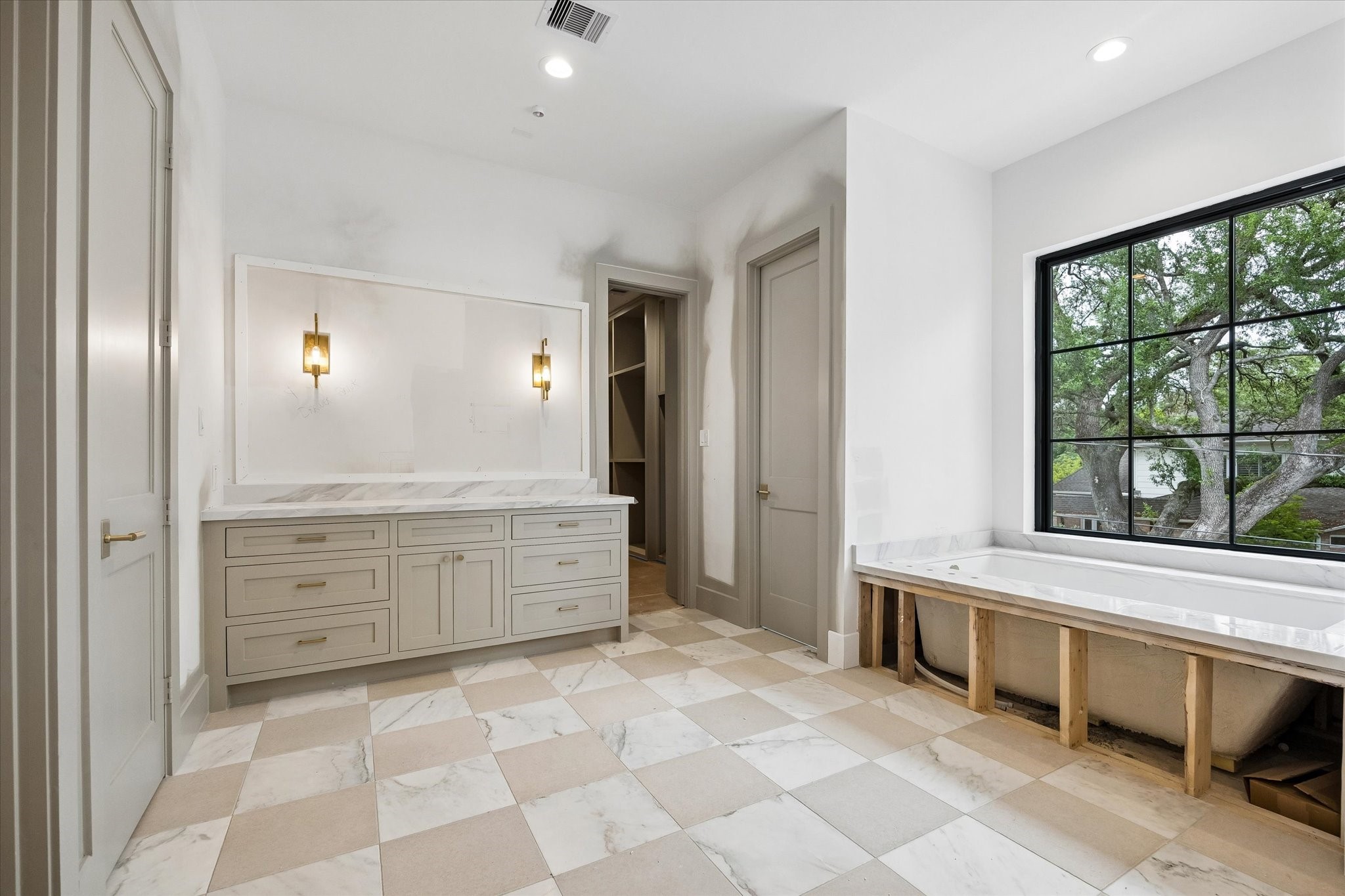 1328 Mickey Way Spring Valley Village, TX 77055 - Photo 13 of 26 Primary bathroom featuring separate water closets, soaking tub and separate vanities. Pictured April 2026.