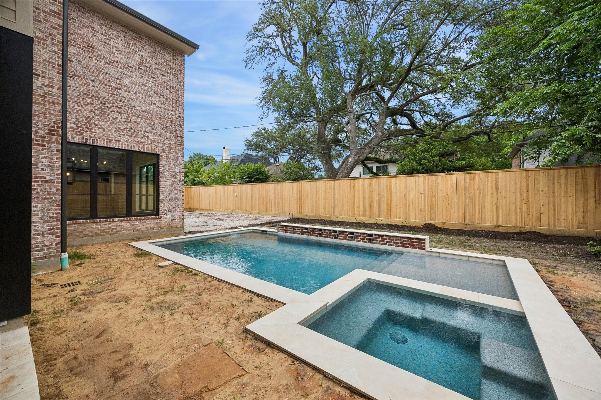 1328 Mickey Way Spring Valley Village, TX 77055 - Photo 18 of 26 This outdoor space is perfect for entertaining with covered outdoor kitchen (not pictured) and pool to be surrounded by artificial turf. Pictured April 2026.