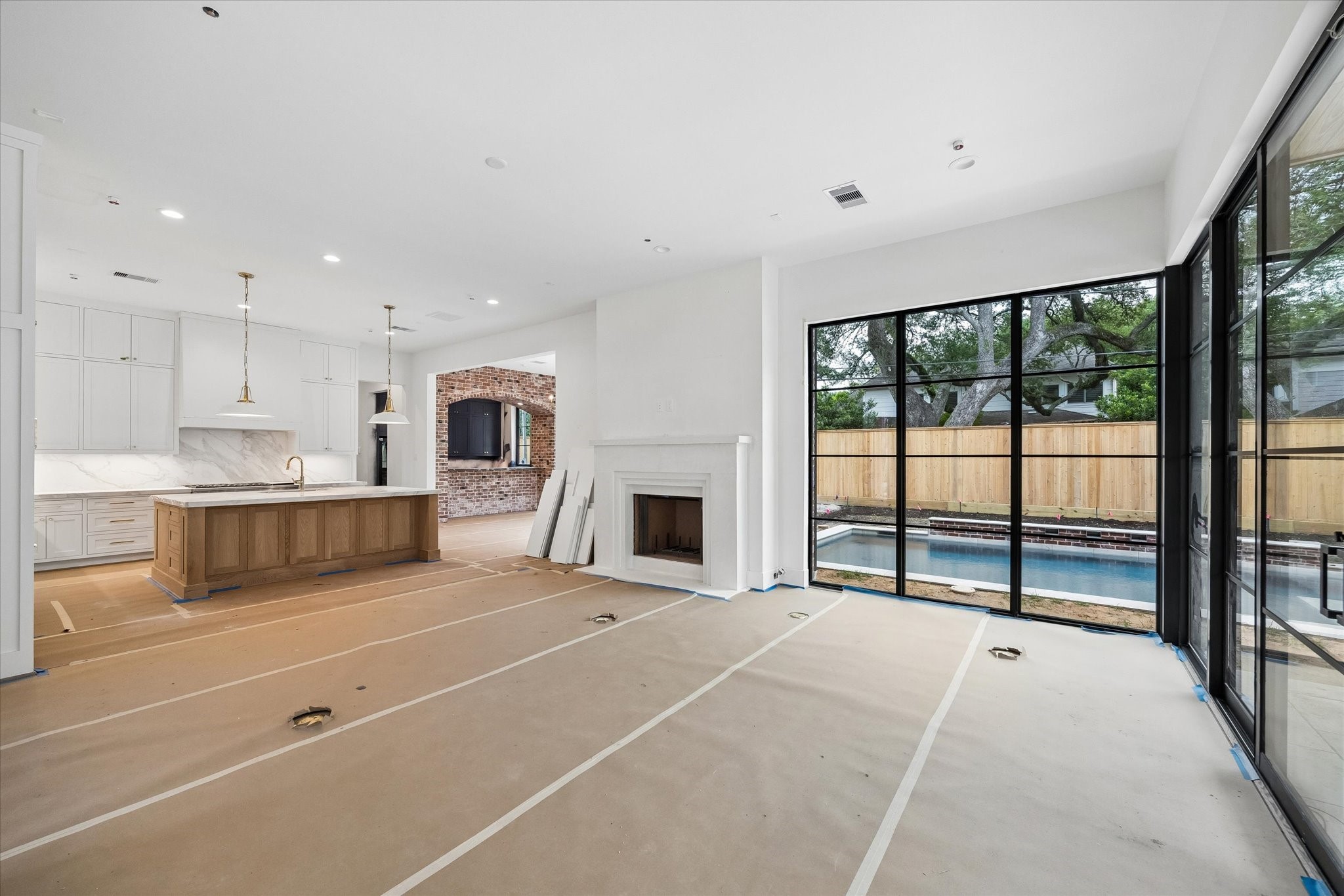 1328 Mickey Way Spring Valley Village, TX 77055 - Photo 3 of 26 Kitchen and adjacent dining room, with a bar just off the dining area featuring a charming exposed brick arch. Pictured April 2026.