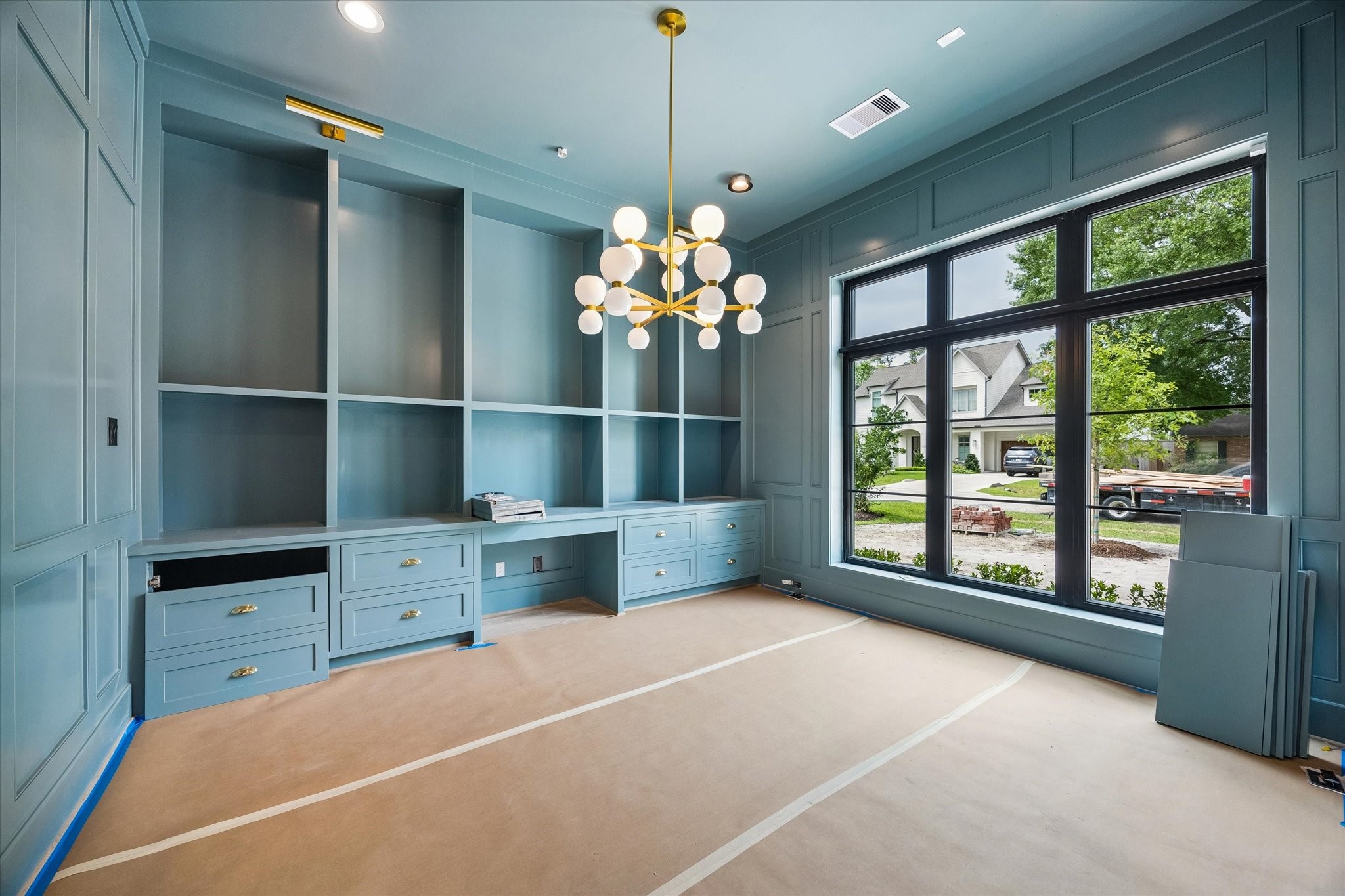 1328 Mickey Way Spring Valley Village, TX 77055 - Photo 10 of 26 Downstairs home office/study with built-in cabinetry and paneled walls. Pictured April 2026.