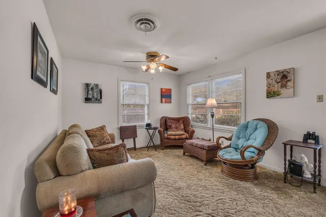 a living room with furniture a chandelier and a window