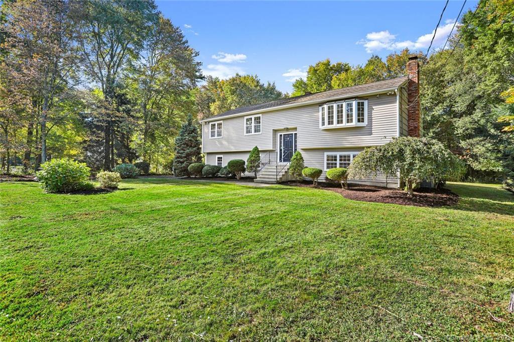 a view of a house with backyard and sitting area