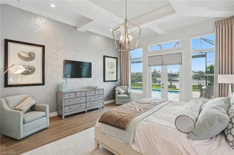 a spacious bedroom with a large bed and a flat screen tv