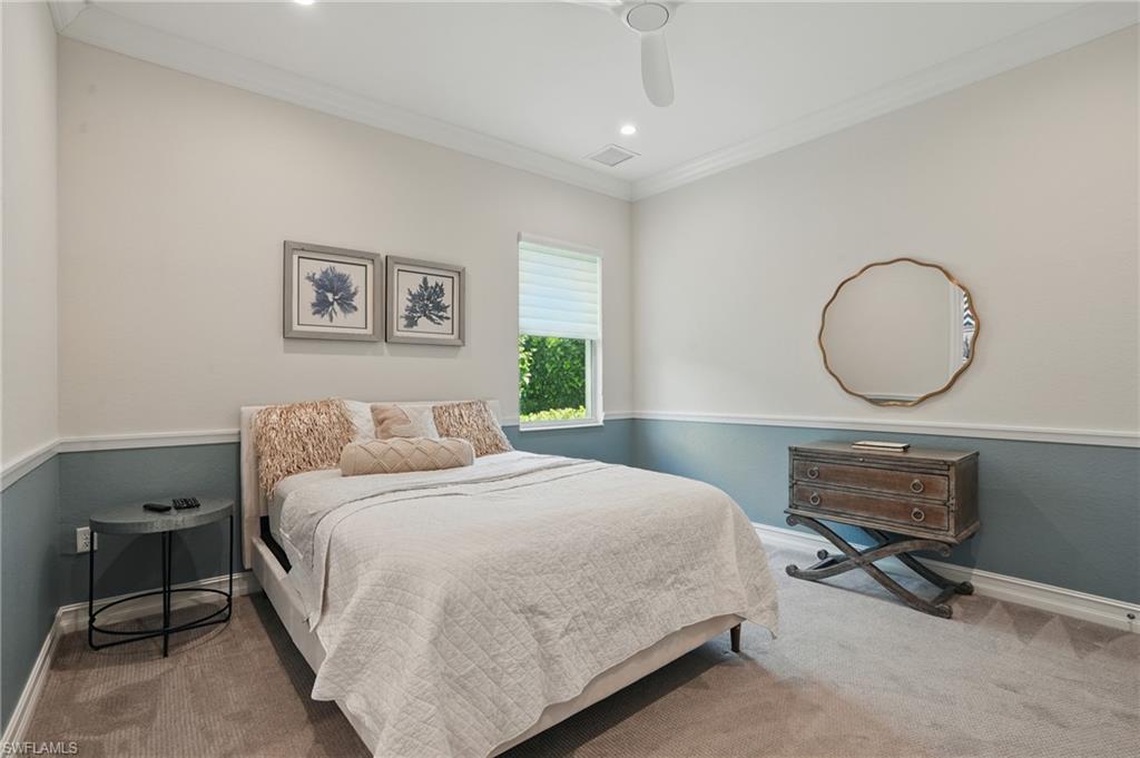 17218 Hidden Estates Circle Fort Myers, FL 33908 - Photo 29 of 50 a bedroom with a bed a mirror and a window