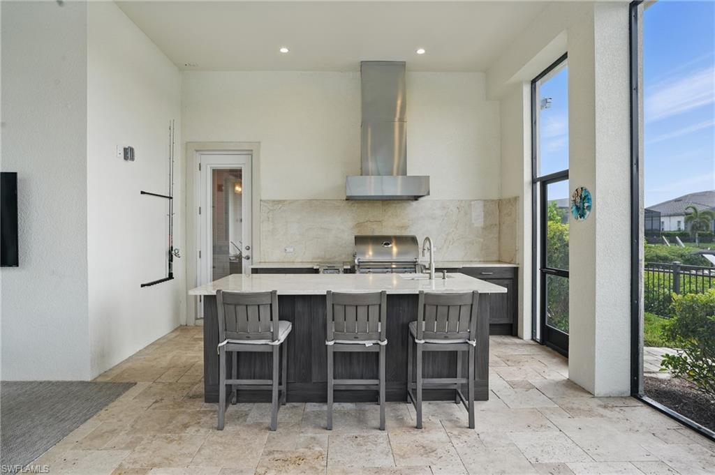 17218 Hidden Estates Circle Fort Myers, FL 33908 - Photo 40 of 50 a white kitchen with a table and chairs in it