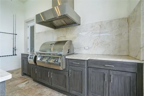 a kitchen with stainless steel appliances granite countertop a sink and cabinets