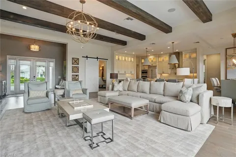 a living room with lots of furniture and a chandelier