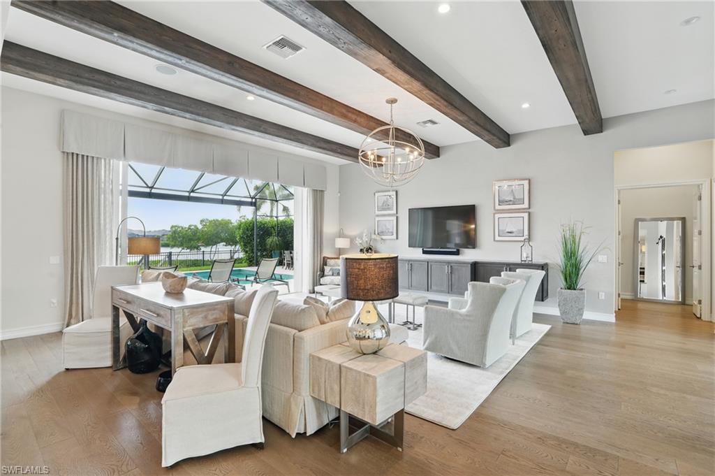 17218 Hidden Estates Circle Fort Myers, FL 33908 - Photo 9 of 50 a living room with furniture a flat screen tv and a floor to ceiling window