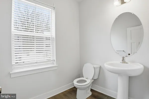 a bathroom with a sink toilet and a mirror