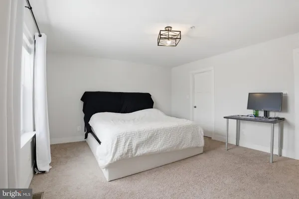 a bedroom with a bed and a chair