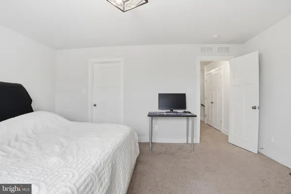 a bedroom with a bed and a television