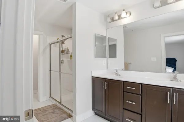 a bathroom with a double vanity sink mirror and