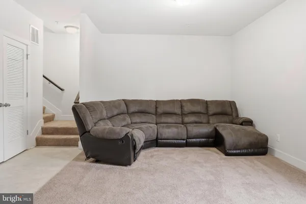 a living room with a couch and a rug