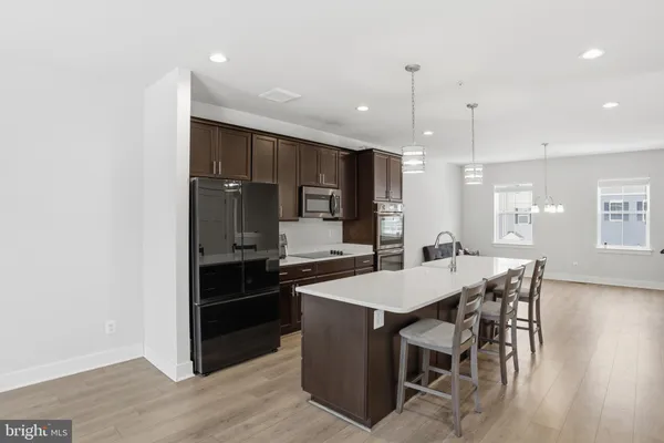 a large kitchen with a table and chairs