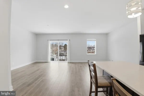 a view of work space with wooden floor and windows