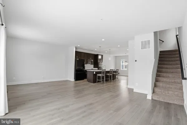 a view of kitchen with furniture and wooden floor