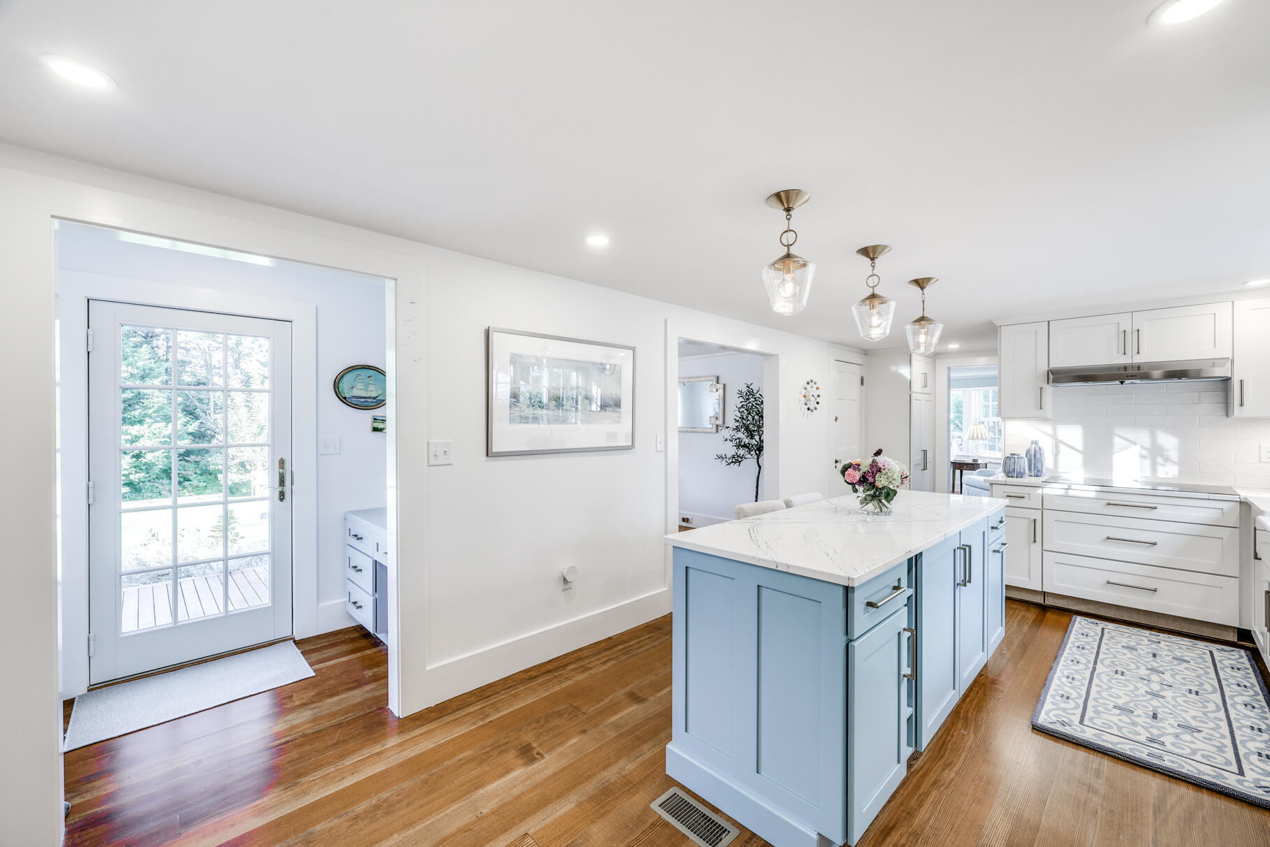 11 Seaview Road Orleans, MA 02653 - Photo 9 of 42 a large kitchen with kitchen island a sink dishwasher a stove and white cabinets with wooden floor