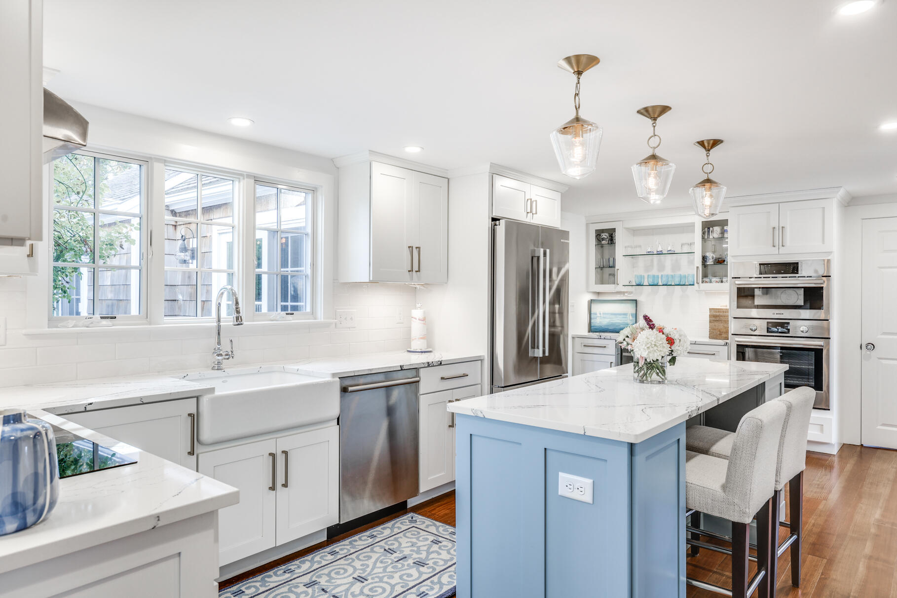 11 Seaview Road Orleans, MA 02653 - Photo 10 of 42 a kitchen with kitchen island granite countertop a sink cabinets stainless steel appliances and a large window