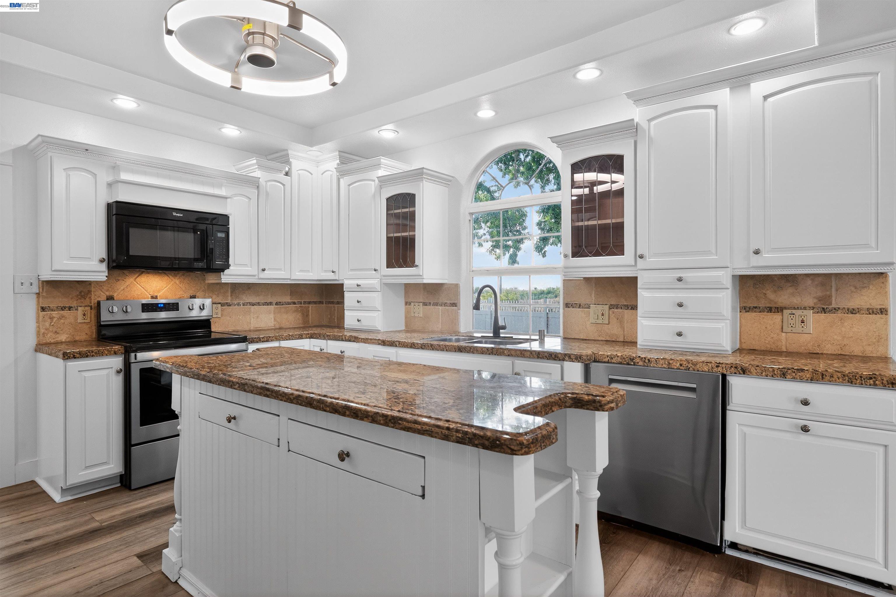3015 Point Pleasant Road Elk Grove, CA 95757 - Photo 9 of 32 a kitchen with granite countertop a sink stainless steel appliances and cabinets