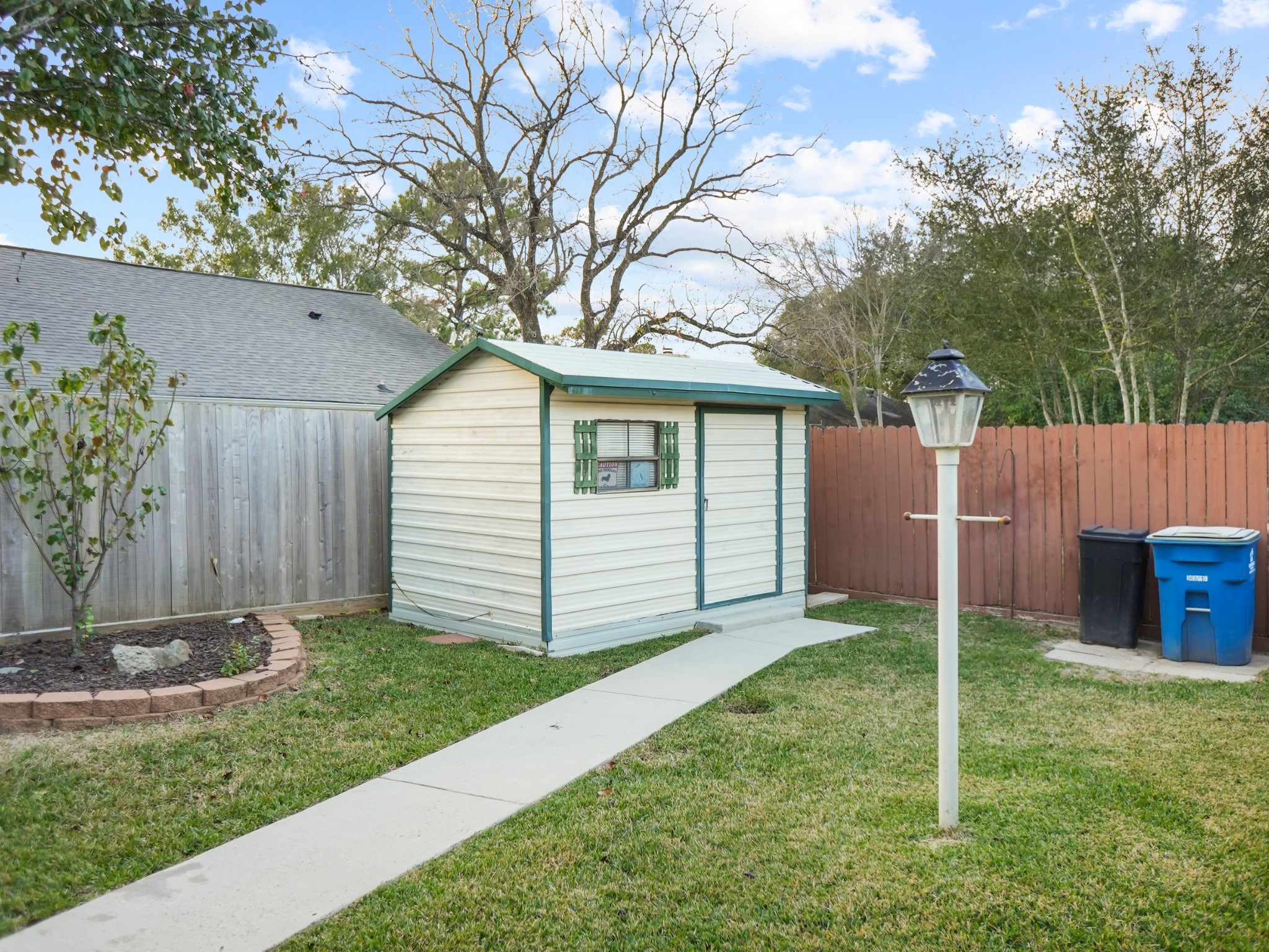 19623 Westbridge Lane Spring, TX 77379 - Photo 39 of 48 a view of a backyard with a garden and trees
