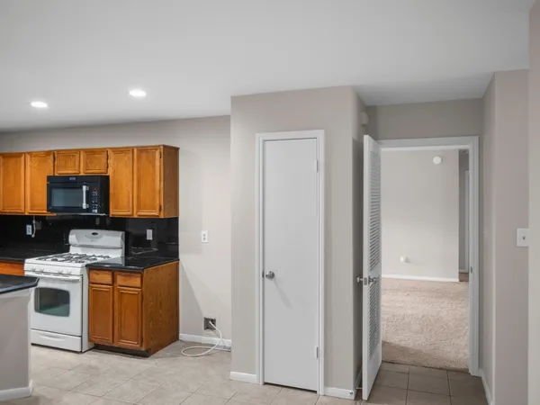 a kitchen with a large window and cabinets