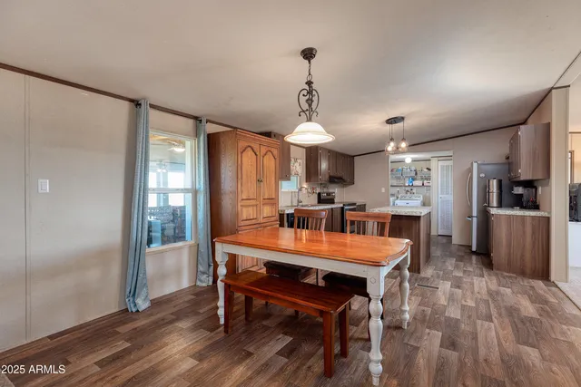 a large kitchen with granite countertop a large counter top space a sink stainless steel appliances and cabinets