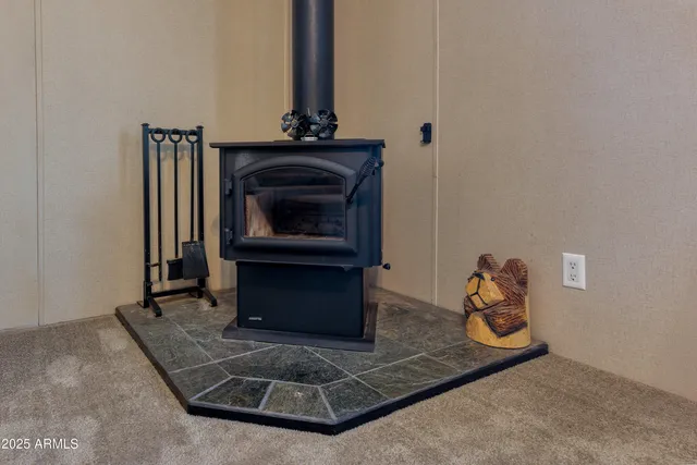 a living room with furniture a flat screen tv and a large window