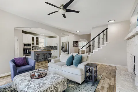 a living room with furniture and view of kitchen