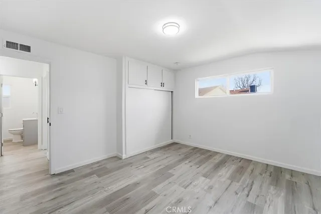 a view of a kitchen with wooden floor and electronic appliances