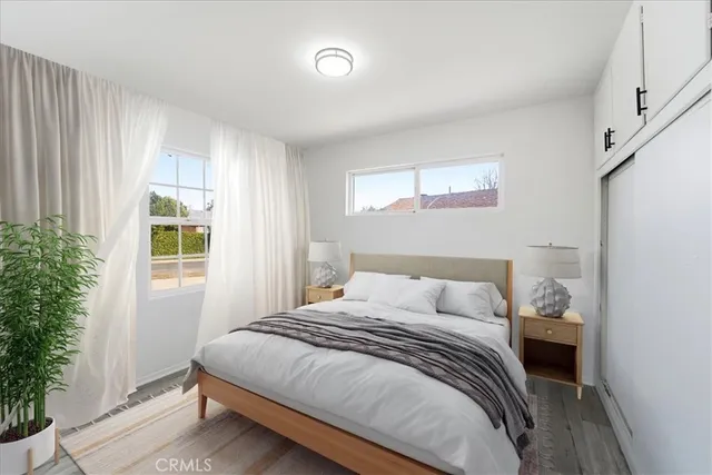 a bedroom with a bed and a window