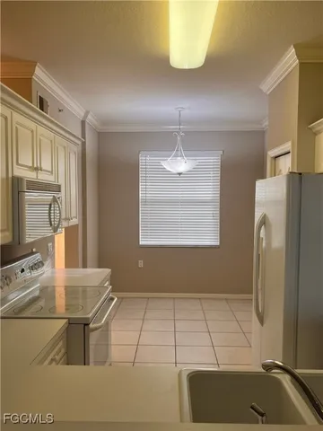 a kitchen with stainless steel appliances kitchen island granite countertop a refrigerator a stove a sink and dishwasher