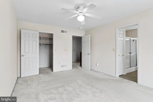 a spacious bathroom with a granite countertop sink a mirror and a bathtub
