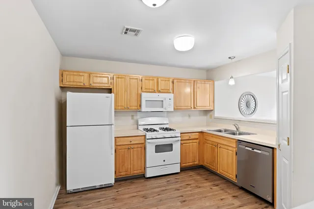 a kitchen with a stove a sink and a refrigerator