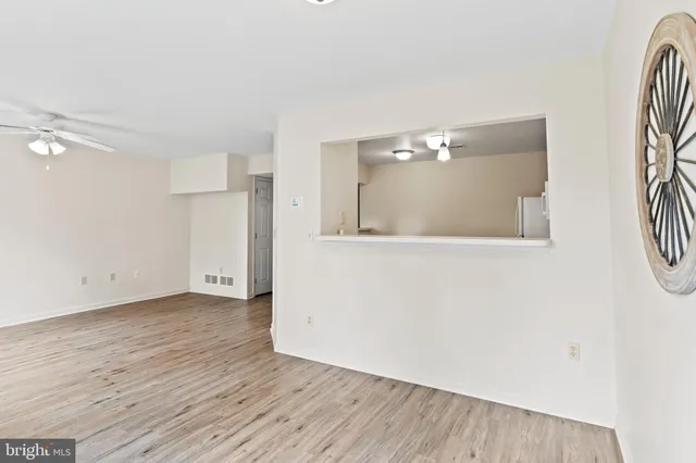 a view of a room with wooden floor and cabinet
