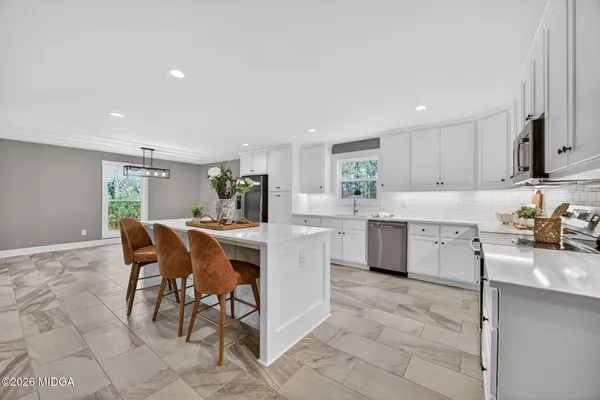 a kitchen with a sink a counter top space and appliances