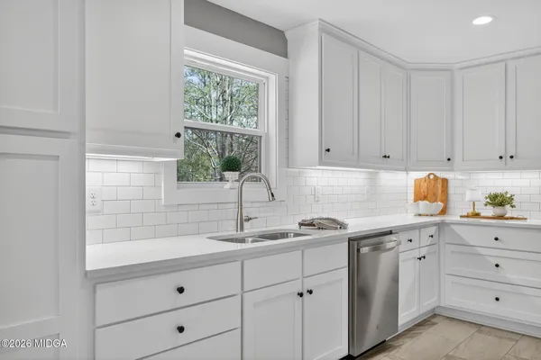 a kitchen with appliances cabinets and a window