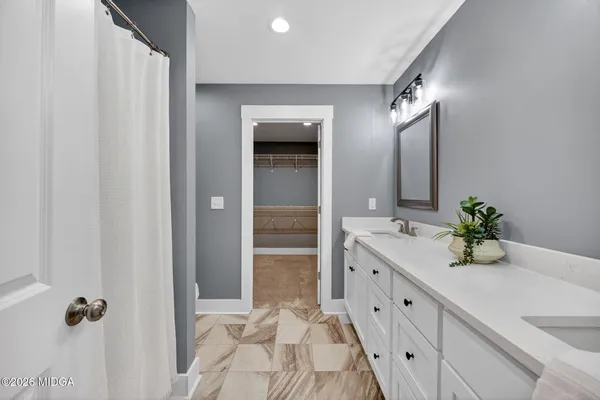 a bathroom with a double vanity sink and mirror
