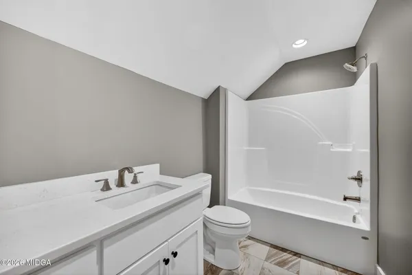 a bathroom with a sink toilet vanity and shower