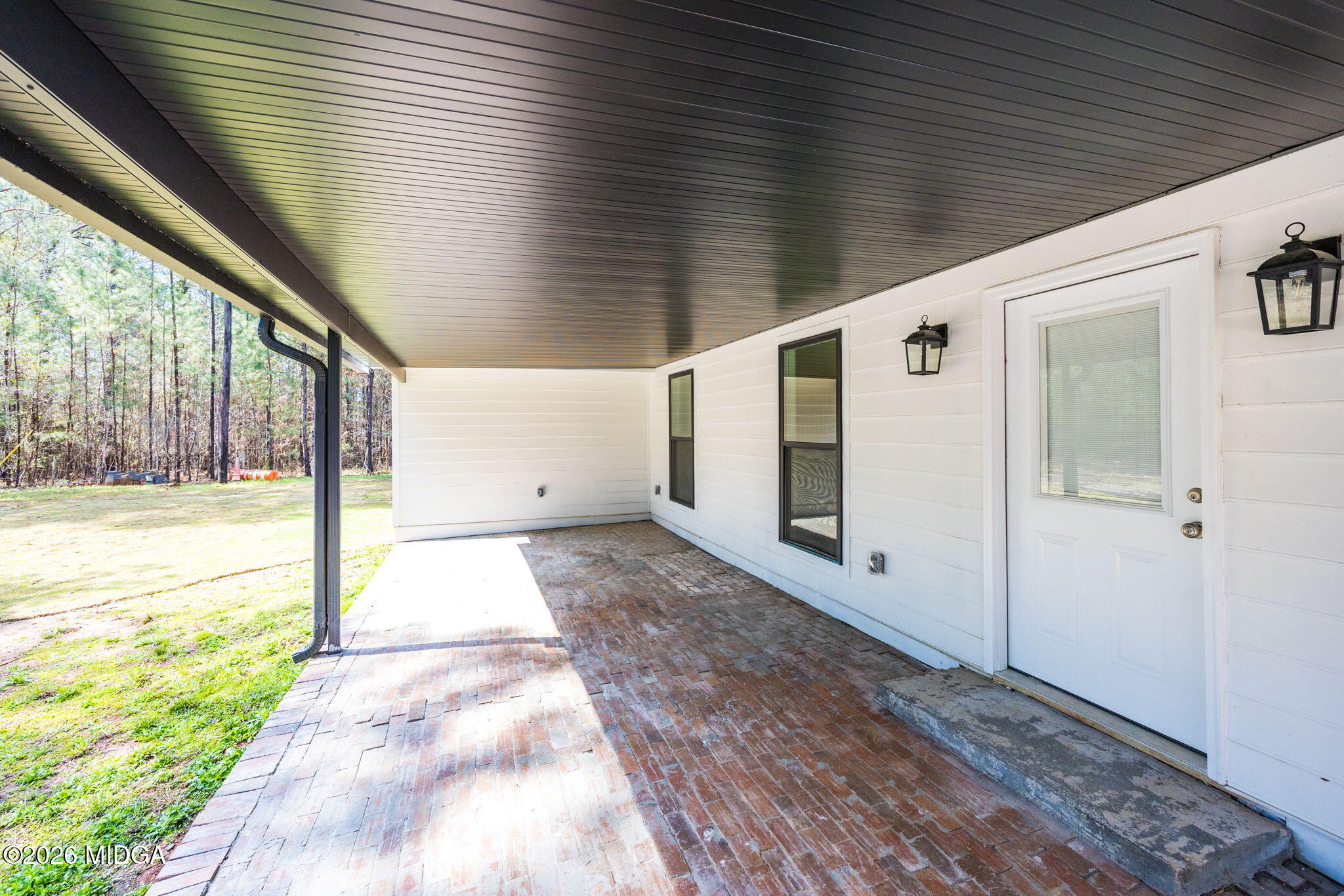 137 Buck Road Gray, GA 31032 - Photo 31 of 35 a view of a porch with a table and chairs and floor to ceiling window