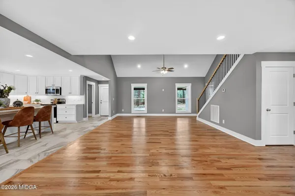 a view of empty room with wooden floor