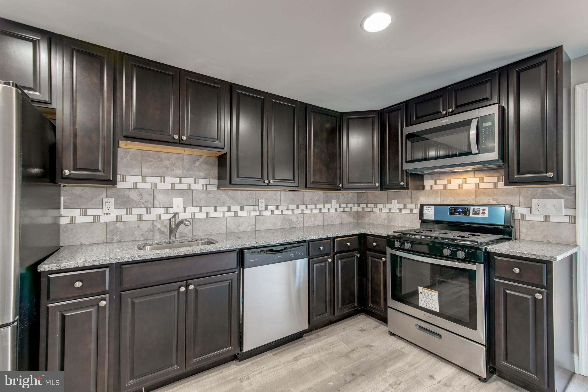 4709 Mawani Road Baltimore, MD 21206 - Photo 2 of 22 Custom Tile Backsplash with beautiful dark cabinet