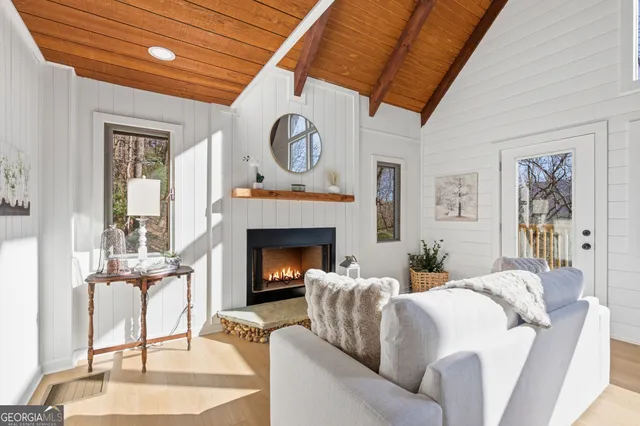 a living room with furniture a clock and a fireplace