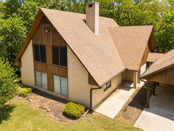 a view of a house with a wooden fence